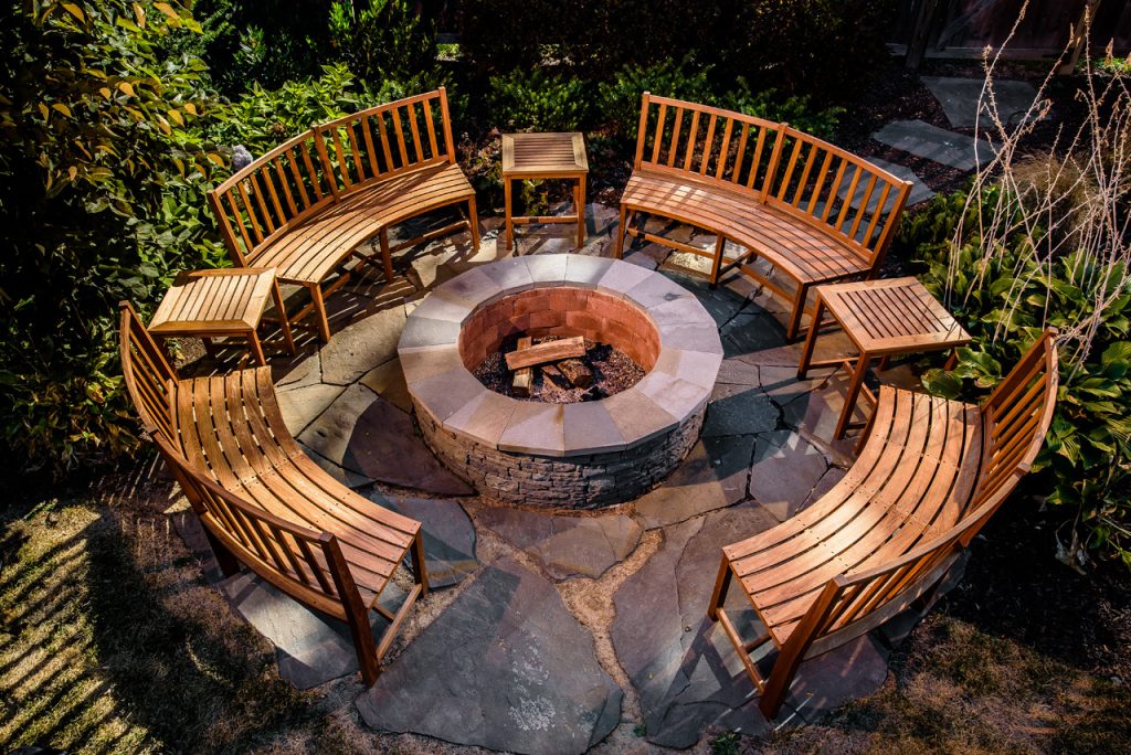Fire pit with wooden benches surrounding it circular